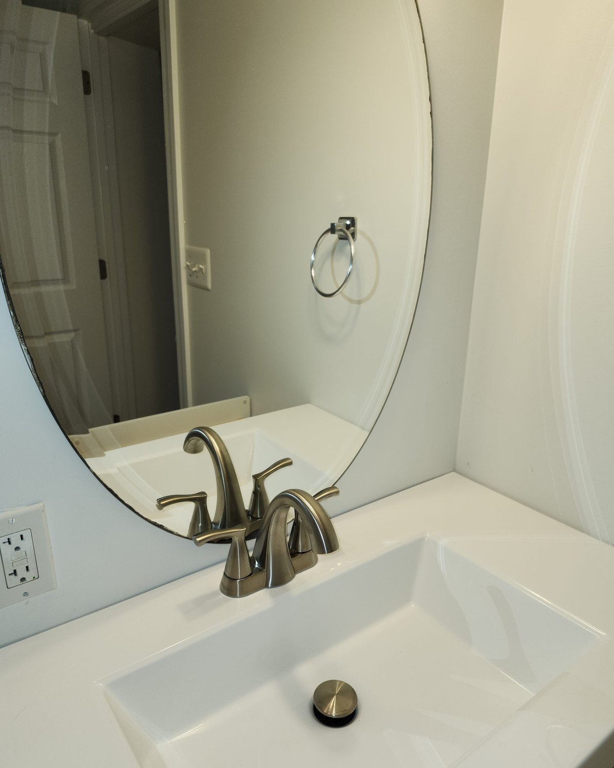 A cleaned bathroom vanity, sink and mirror — a photograph of Perham Services’ own work